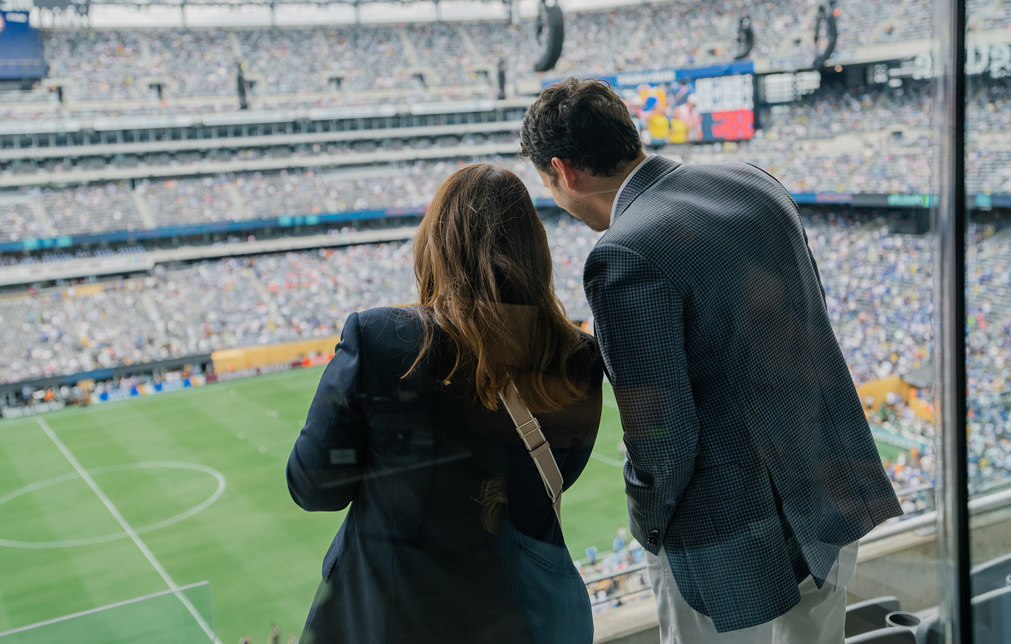 Fans watching a FIFA World Cup match from a private suite